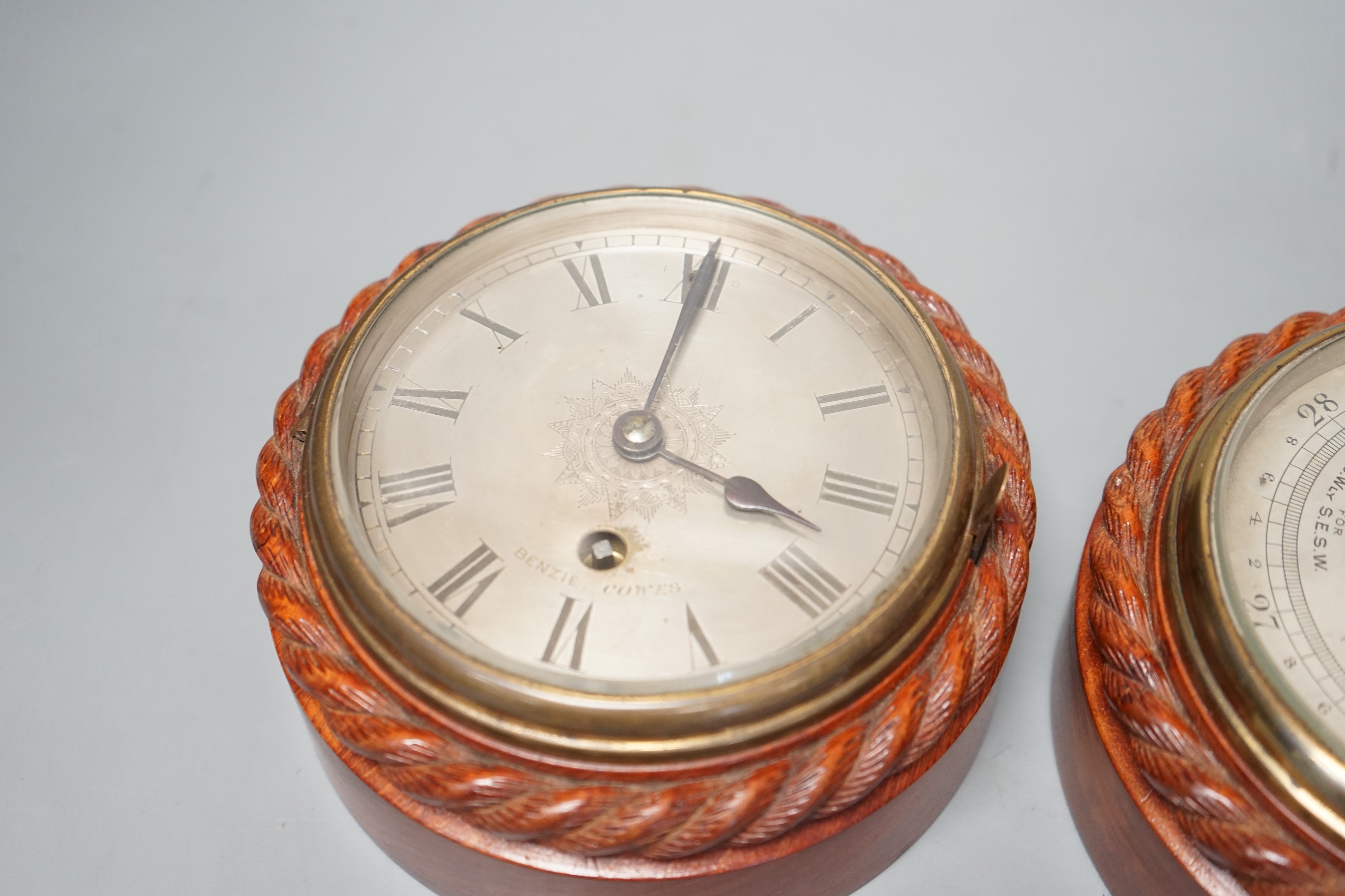 A Victorian teak cased bulkhead timepiece by Benzie, Cowes, Isle of Wight with matching aneroid barometer, both with carved rope twist cases, 15cm. diam.